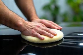 Detailer waxing car with eco-safe product